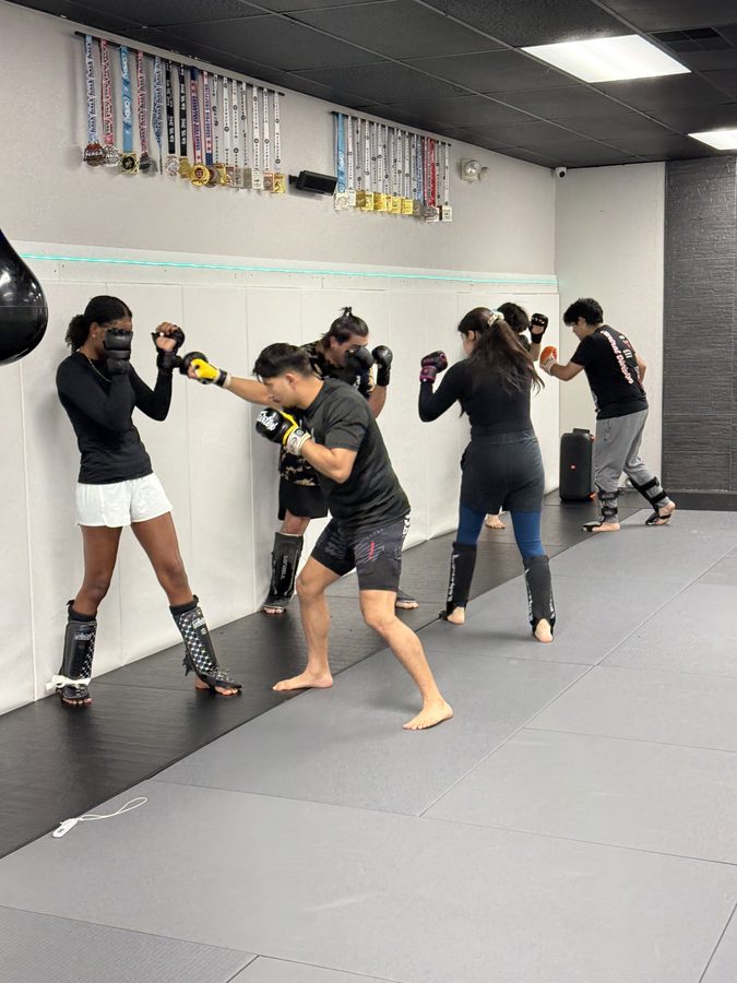 Kickboxing class working combinations on the mats